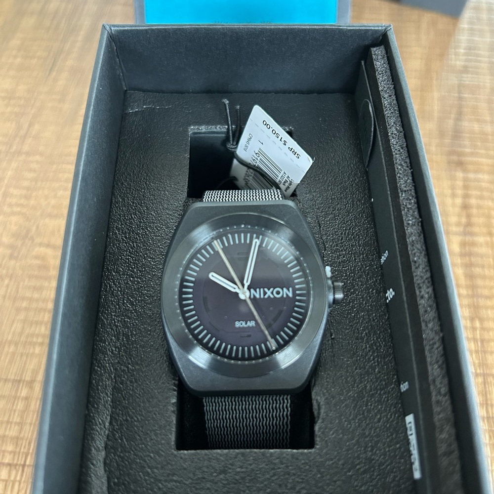 Brand new black Nixon solar powered watch.